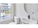 Bathroom featuring a modern sink, toilet, and window providing natural light at 2637 Camphor Se Xing # 83, Smyrna, GA 30080