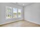 Bright bedroom with large windows offering neighborhood views and natural light on hardwood flooring at 2637 Camphor Se Xing # 83, Smyrna, GA 30080