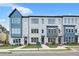 Modern townhouse featuring a gray brick facade, large windows, and well-manicured landscaping at 2637 Camphor Se Xing # 83, Smyrna, GA 30080