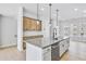 Bright kitchen features a center island with pendant lighting, stainless steel dishwasher, and hardwood floors at 2637 Camphor Se Xing # 83, Smyrna, GA 30080