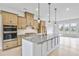 Modern kitchen features a large center island, stainless steel appliances, and light wood cabinets at 2637 Camphor Se Xing # 83, Smyrna, GA 30080