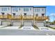 Rear exterior of newly built townhomes featuring garage entries and decks at 2637 Camphor Se Xing # 83, Smyrna, GA 30080