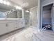 Spacious bathroom featuring dual sinks, a large mirror, and a frameless glass shower at 1397 Fern Ridge Ct # 34, Norcross, GA 30093