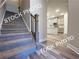 Welcoming entryway with staircase, hardwood floors, and a view of the modern kitchen at 1397 Fern Ridge Ct # 34, Norcross, GA 30093