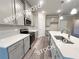 Well lit kitchen featuring gray cabinets, stainless steel appliances, an island and modern lighting at 1397 Fern Ridge Ct # 34, Norcross, GA 30093