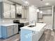 Bright kitchen featuring gray cabinets, stainless steel appliances, an island and modern lighting at 1397 Fern Ridge Ct # 34, Norcross, GA 30093