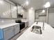Well lit kitchen featuring gray cabinets, stainless steel appliances, an island and modern lighting at 1397 Fern Ridge Ct # 34, Norcross, GA 30093