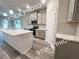 Modern kitchen features gray cabinets, stainless steel appliances and a central island with a white countertop at 1397 Fern Ridge Ct # 34, Norcross, GA 30093