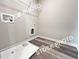 A spacious laundry room with hardwood floors and a white wire rack shelf at 1397 Fern Ridge Ct # 34, Norcross, GA 30093