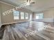 Bright living room with large windows, hardwood floors, ceiling fan, and modern trim at 1397 Fern Ridge Ct # 34, Norcross, GA 30093