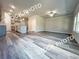 Open floor plan with hardwood floors connects kitchen and living room, filled with natural light at 1397 Fern Ridge Ct # 34, Norcross, GA 30093