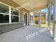 Screened-in porch with brick accents, concrete floors, and access to the backyard at 1397 Fern Ridge Ct # 34, Norcross, GA 30093