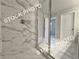 Stylish shower with marble-like tiles and a sleek glass enclosure at 1397 Fern Ridge Ct # 34, Norcross, GA 30093