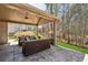 Covered back patio featuring a ceiling fan, patio furniture, and manicured lawn at 2096 Hamilton Lake Pkwy, Buford, GA 30519