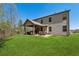 View of backyard and covered patio with seating, and an expansive lawn at 2096 Hamilton Lake Pkwy, Buford, GA 30519
