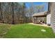 Large backyard with covered patio, lush green grass, and wooded area at 2096 Hamilton Lake Pkwy, Buford, GA 30519