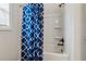 Bathroom with a blue and white shower curtain and a tub at 2096 Hamilton Lake Pkwy, Buford, GA 30519