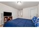 Bedroom with a bed, wall-mounted TV, dark furniture, and a neutral carpet at 2096 Hamilton Lake Pkwy, Buford, GA 30519