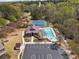Aerial view of a community pool with tennis courts, a clubhouse, and ample parking at 2096 Hamilton Lake Pkwy, Buford, GA 30519