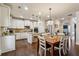 Eat-in kitchen features a large island with seating, granite countertops, and white cabinets at 2096 Hamilton Lake Pkwy, Buford, GA 30519