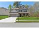 Well-maintained two-story home with lush green lawn, a convenient two-car garage, and sidewalk at 2096 Hamilton Lake Pkwy, Buford, GA 30519