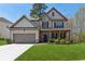 Charming two-story home with a well-manicured lawn, inviting entrance and attached two car garage at 2096 Hamilton Lake Pkwy, Buford, GA 30519