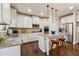 Modern kitchen features granite countertops, stainless steel appliances, and a large island with seating at 2096 Hamilton Lake Pkwy, Buford, GA 30519