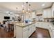 Open-concept kitchen with island seating, granite countertops and access to the outdoor dining area at 2096 Hamilton Lake Pkwy, Buford, GA 30519