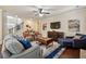 Comfortable living room with hardwood floors, large windows, and an open staircase at 2096 Hamilton Lake Pkwy, Buford, GA 30519