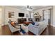 Cozy living room featuring a stone fireplace, hardwood floors, and large windows at 2096 Hamilton Lake Pkwy, Buford, GA 30519