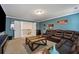 Open living room with plush leather seating, plush carpet, and access to the stairway at 2096 Hamilton Lake Pkwy, Buford, GA 30519