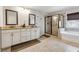 Well-lit main bathroom with double vanity, soaking tub, and glass-enclosed shower at 2096 Hamilton Lake Pkwy, Buford, GA 30519