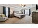 Spacious main bedroom with a tray ceiling, plush carpet, and two arm chairs at 2096 Hamilton Lake Pkwy, Buford, GA 30519