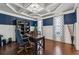 Stylish home office with rich blue walls, white wainscoting, coffered ceiling, and hardwood floors at 2096 Hamilton Lake Pkwy, Buford, GA 30519