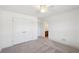 Neutral bedroom featuring white trim, closet with double doors, ceiling fan and neutral carpet at 5615 Toccoa Dr, Douglasville, GA 30135