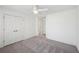 Neutral bedroom featuring white trim, closet with double doors, ceiling fan and neutral carpet at 5615 Toccoa Dr, Douglasville, GA 30135