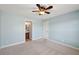 Light and airy bedroom features soft carpeting and a ceiling fan at 5615 Toccoa Dr, Douglasville, GA 30135