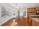 Bright dining area featuring hardwood floors, large windows, and a view to the kitchen and staircase at 5615 Toccoa Dr, Douglasville, GA 30135