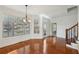 Bright dining area with hardwood floors, large windows with wooded views, and modern lighting at 5615 Toccoa Dr, Douglasville, GA 30135