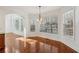 Bright dining area with hardwood floors, large windows with wooded views, and modern lighting at 5615 Toccoa Dr, Douglasville, GA 30135
