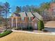 View of a stately brick home with a manicured lawn and mature landscaping at 5615 Toccoa Dr, Douglasville, GA 30135