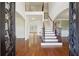 Elegant foyer features a grand staircase with wooden railings and hardwood floors at 5615 Toccoa Dr, Douglasville, GA 30135