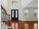 Spacious foyer with an arched entrance, ornate double doors, and a view of the upper level at 5615 Toccoa Dr, Douglasville, GA 30135