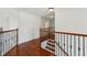 Hallway with hardwood floors, wrought iron railing, and access to various rooms at 5615 Toccoa Dr, Douglasville, GA 30135
