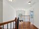 Hallway overlooking the foyer with hardwood floors, wrought iron railing, and many windows at 5615 Toccoa Dr, Douglasville, GA 30135
