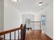 Hallway overlooking the foyer with hardwood floors, wrought iron railing, and many windows at 5615 Toccoa Dr, Douglasville, GA 30135