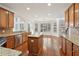 Open kitchen featuring wood cabinets, granite countertops, and a view of the dining area at 5615 Toccoa Dr, Douglasville, GA 30135