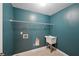 Functional laundry room with a utility sink, shelving, and blue walls at 5615 Toccoa Dr, Douglasville, GA 30135