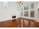 Bright living room featuring a fireplace, hardwood floors, and large windows with wooded views at 5615 Toccoa Dr, Douglasville, GA 30135