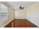 Spacious living room with gleaming hardwood floors, crown molding, and ample natural light from the two windows at 5615 Toccoa Dr, Douglasville, GA 30135